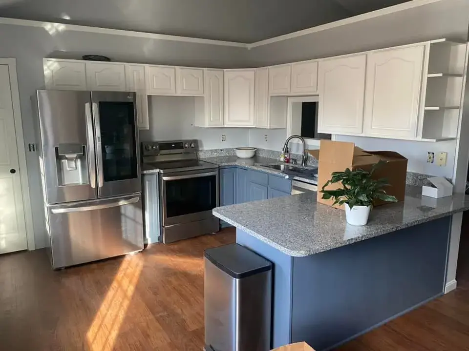 After: kitchen oak cabinets to white uppers and blue-gray lowers