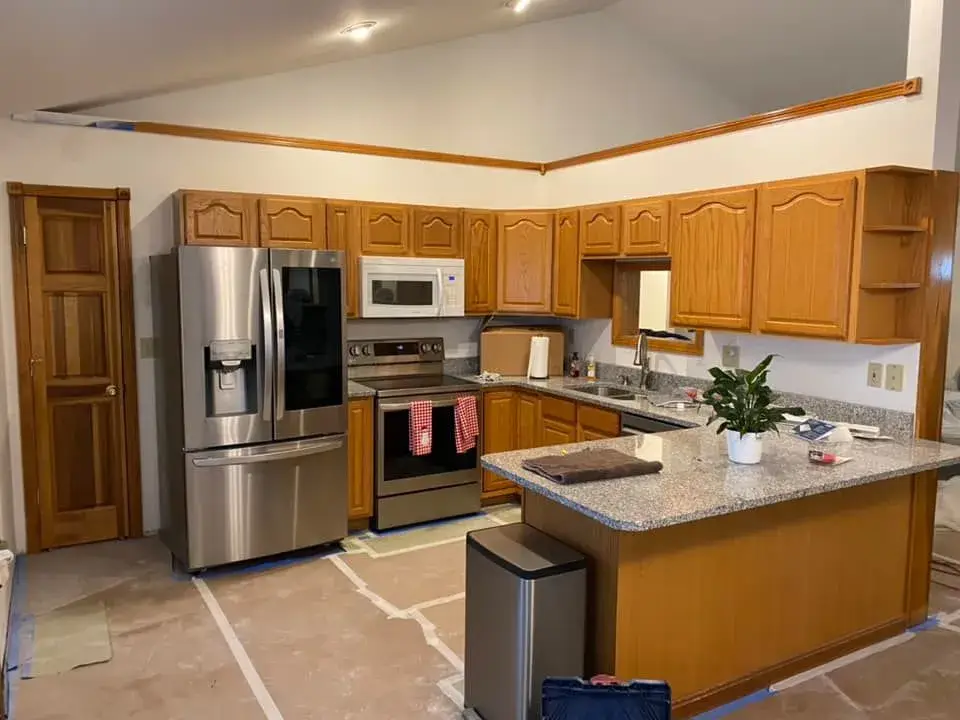 Before: kitchen oak cabinets to white uppers and blue-gray lowers
