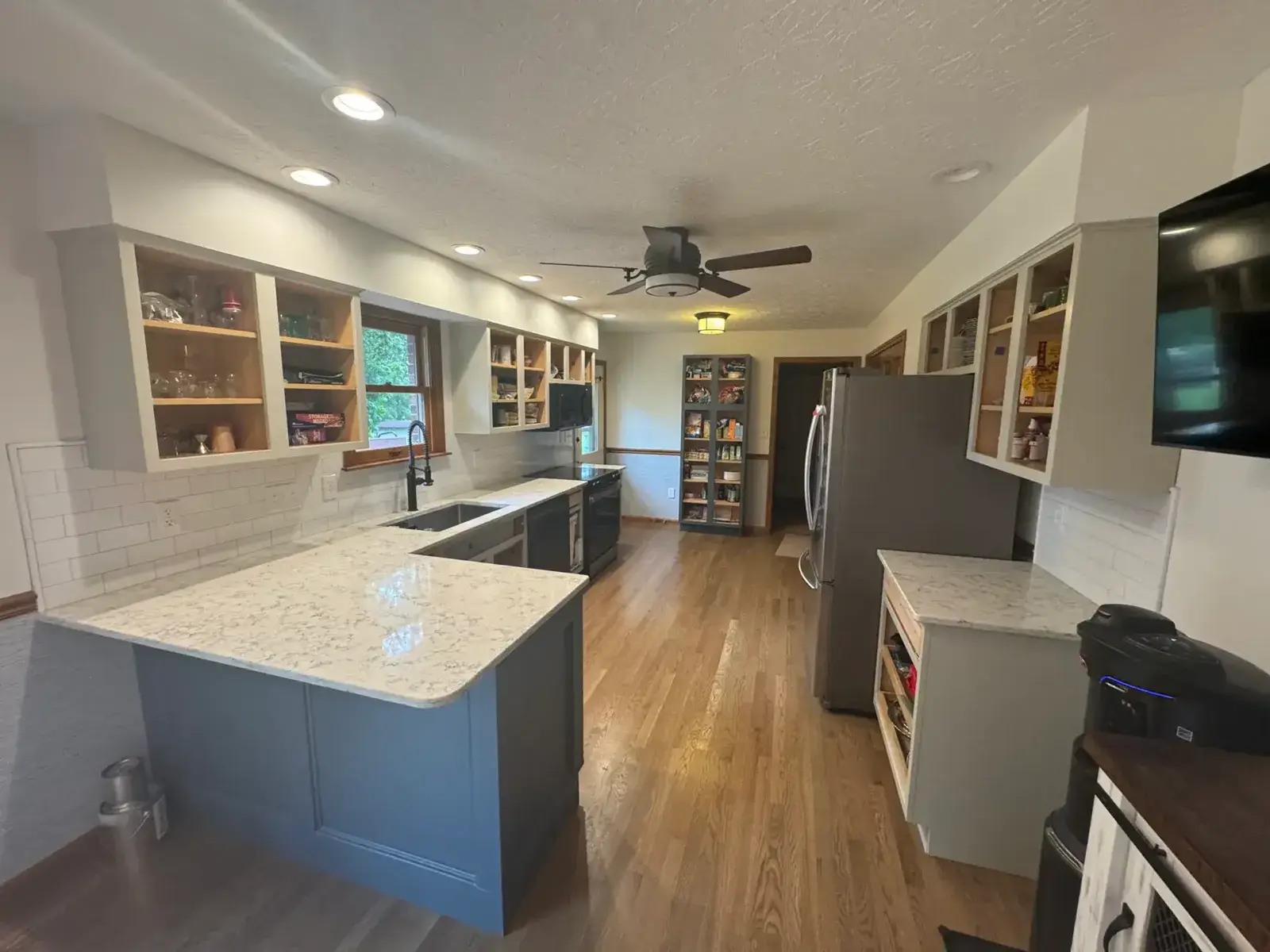 After: kitchen open-shelf wood cabinets painted gray
