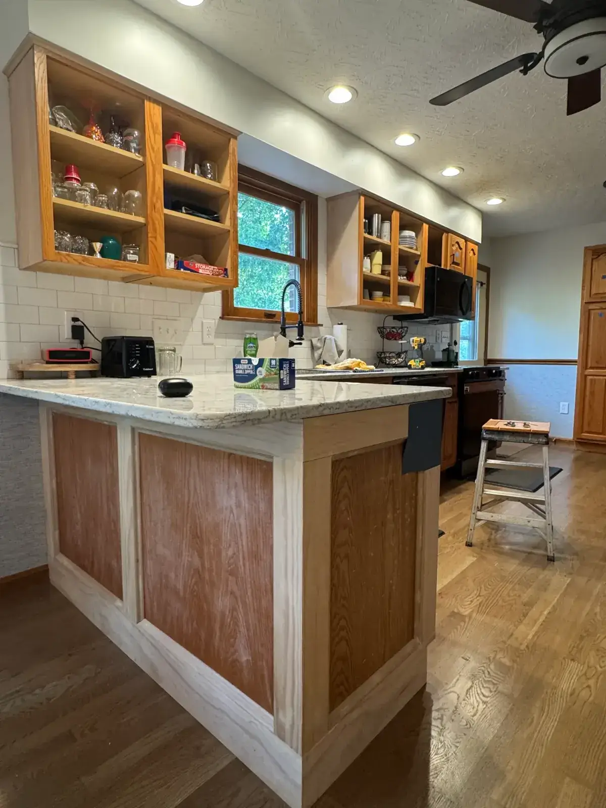 Before: kitchen open-shelf wood cabinets painted gray