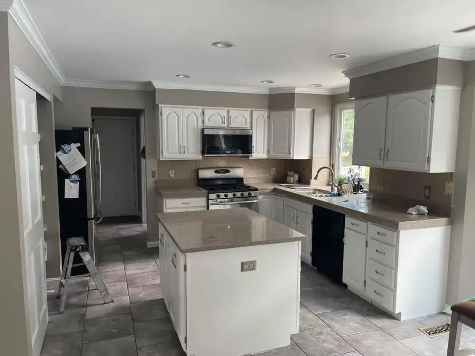After: kitchen painted white, living room and dining room repainted