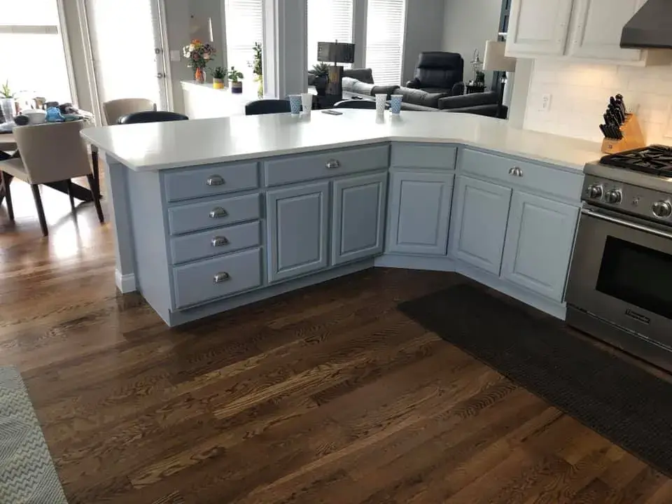 After: kitchen with arched window: cabinets refinished, white uppers and blue-gray lowers