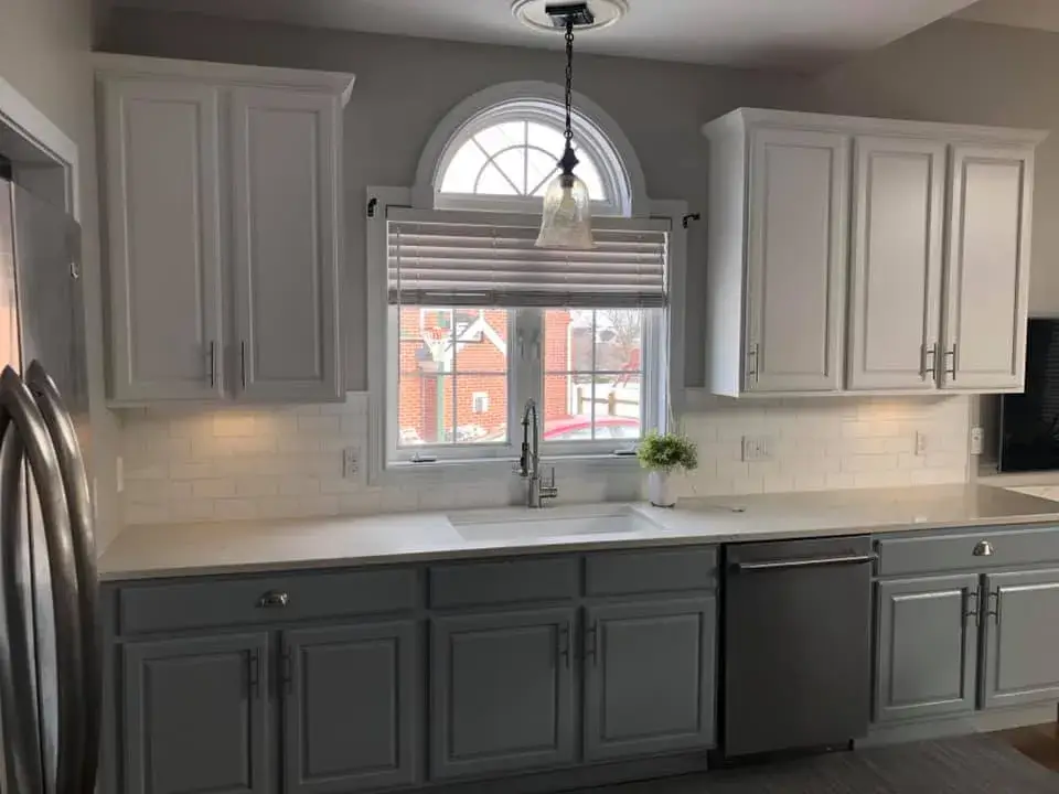 After: kitchen with arched window: cabinets refinished, white uppers and blue-gray lowers