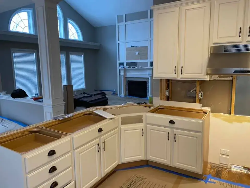 In progress: kitchen with arched window: cabinets refinished, white uppers and blue-gray lowers