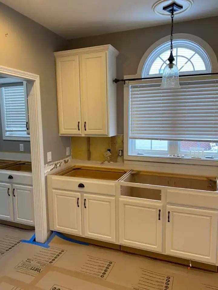 In progress: kitchen with arched window: cabinets refinished, white uppers and blue-gray lowers