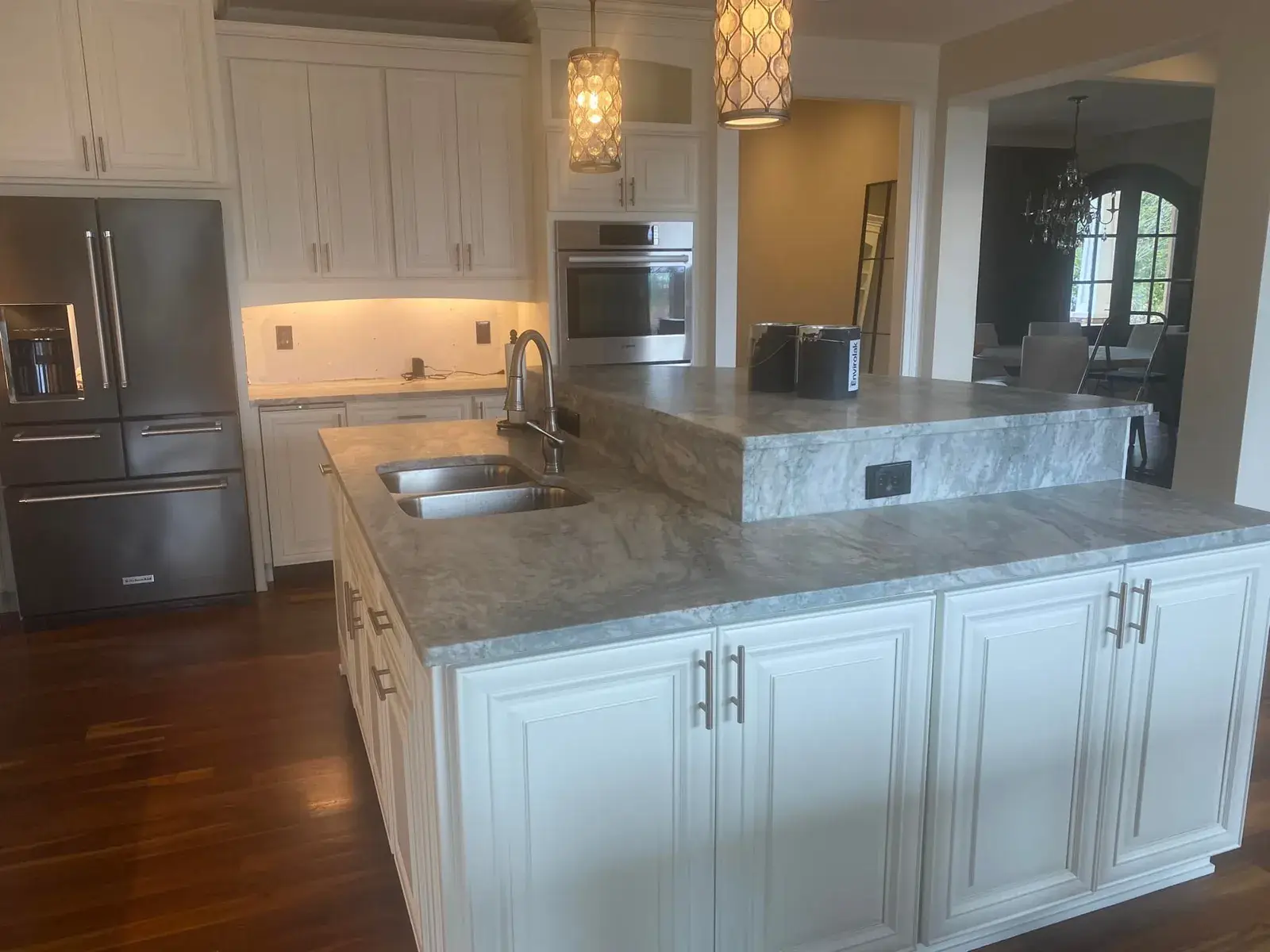 Before: kitchen with two islands: white cabinets painted dark