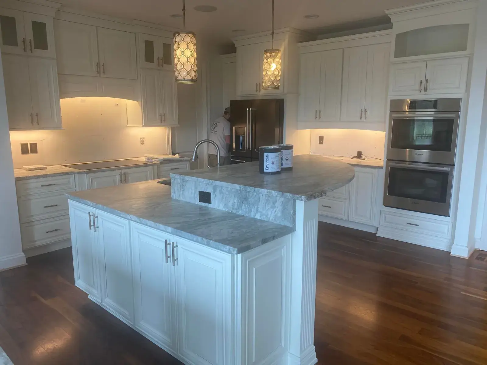 Before: kitchen with two islands: white cabinets painted dark