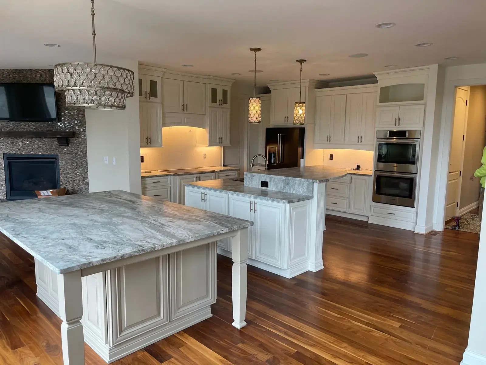 Before: kitchen with two islands: white cabinets painted dark