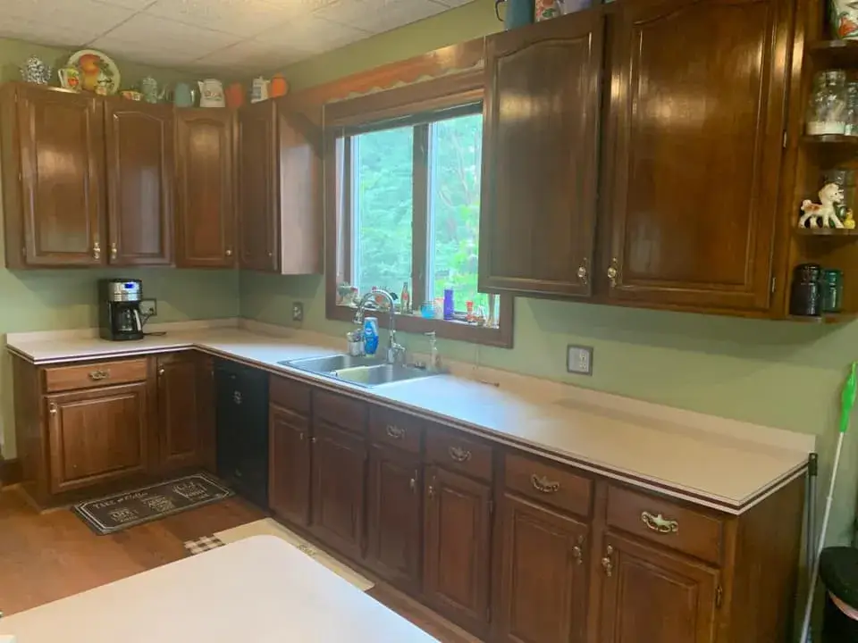 Before: kitchen wood cabinets painted dark