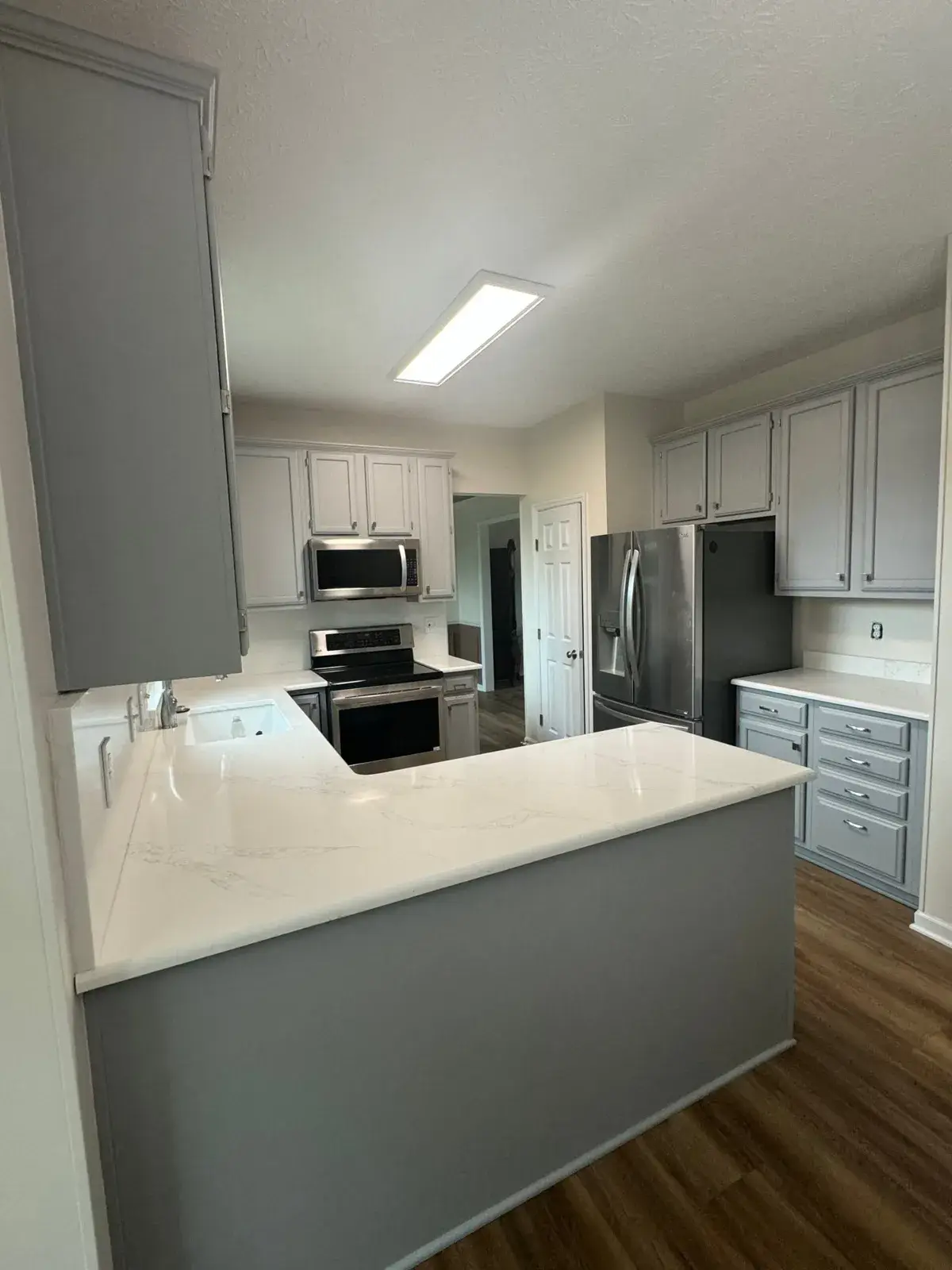 After: kitchen wood cabinets painted gray