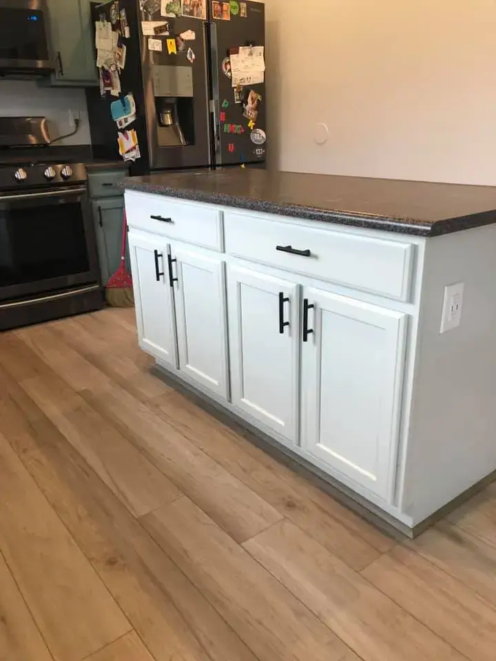 After: kitchen wood cabinets painted teal with a white island