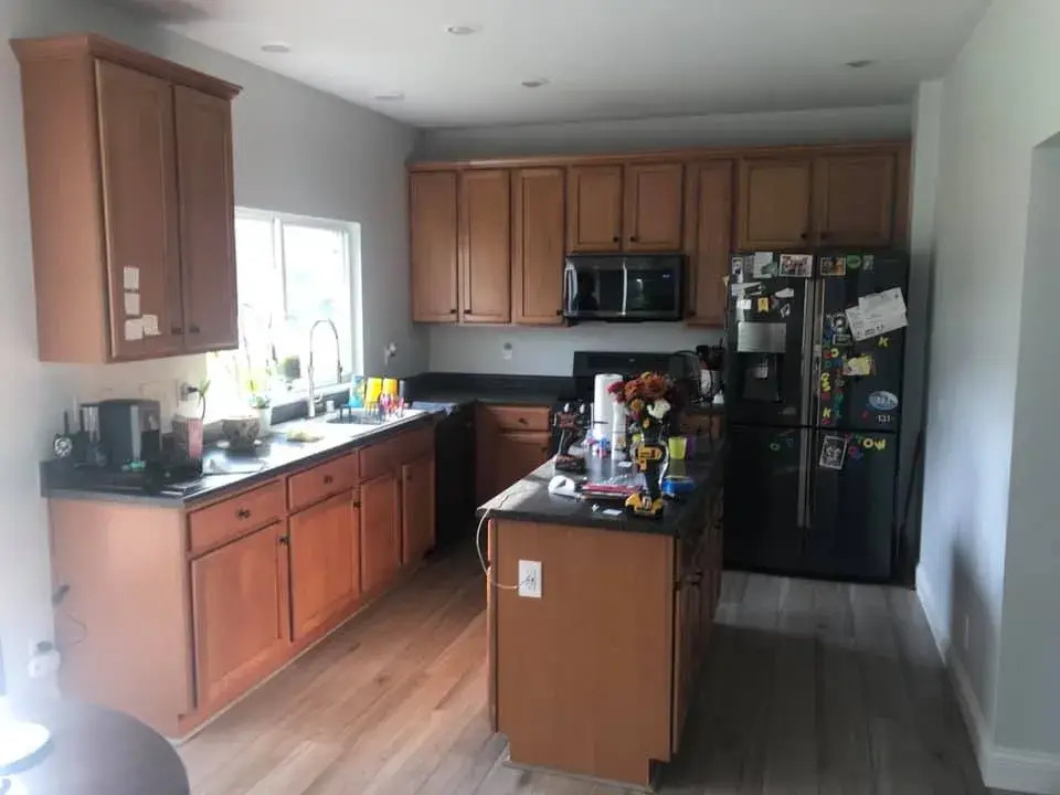 Before: kitchen wood cabinets painted teal with a white island