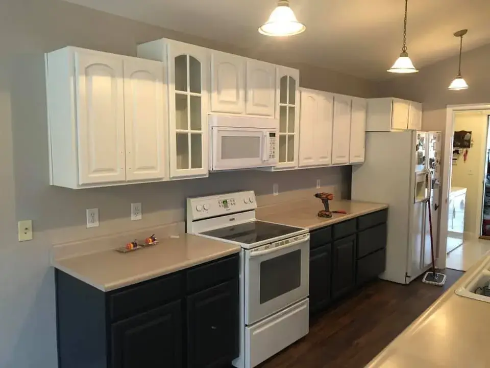 After: kitchen wood cabinets painted white uppers, dark lowers