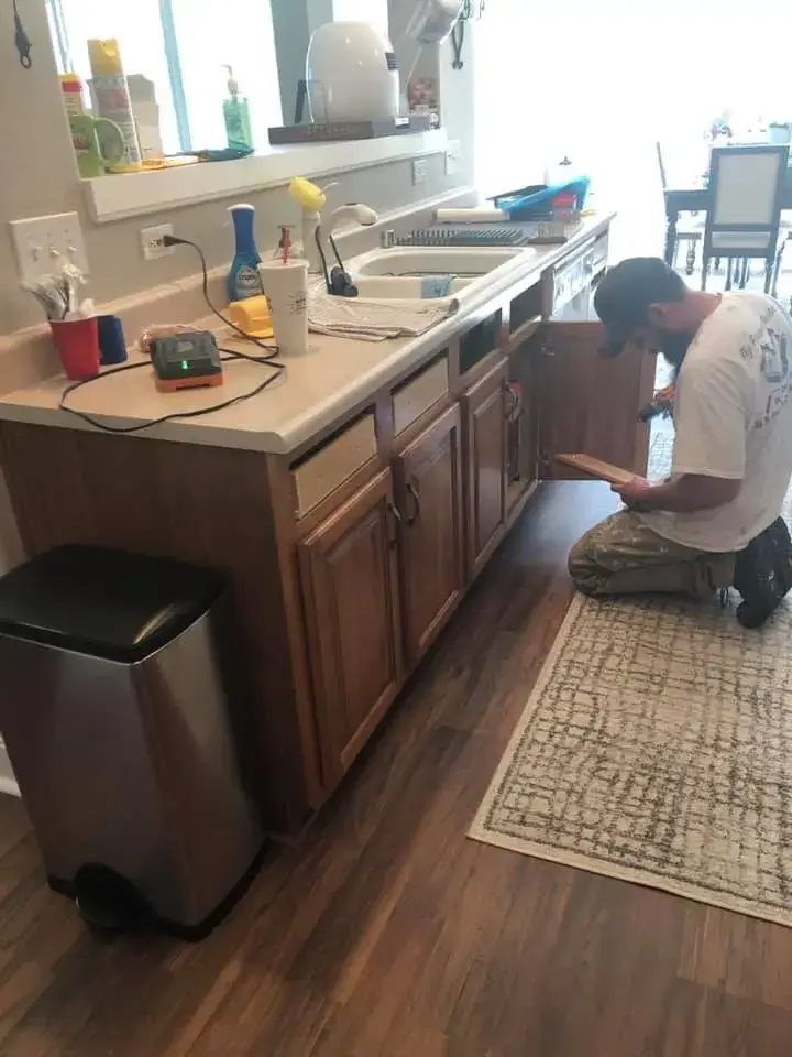 In progress: kitchen wood cabinets painted white uppers, dark lowers