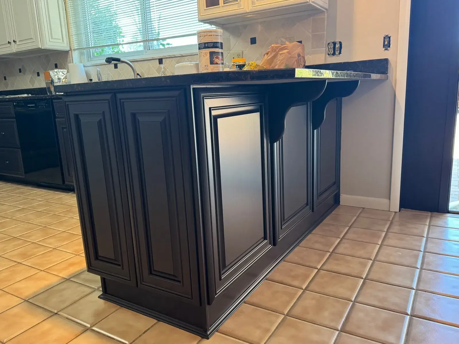 After: kitchen wood cabinets to white uppers with a dark peninsula