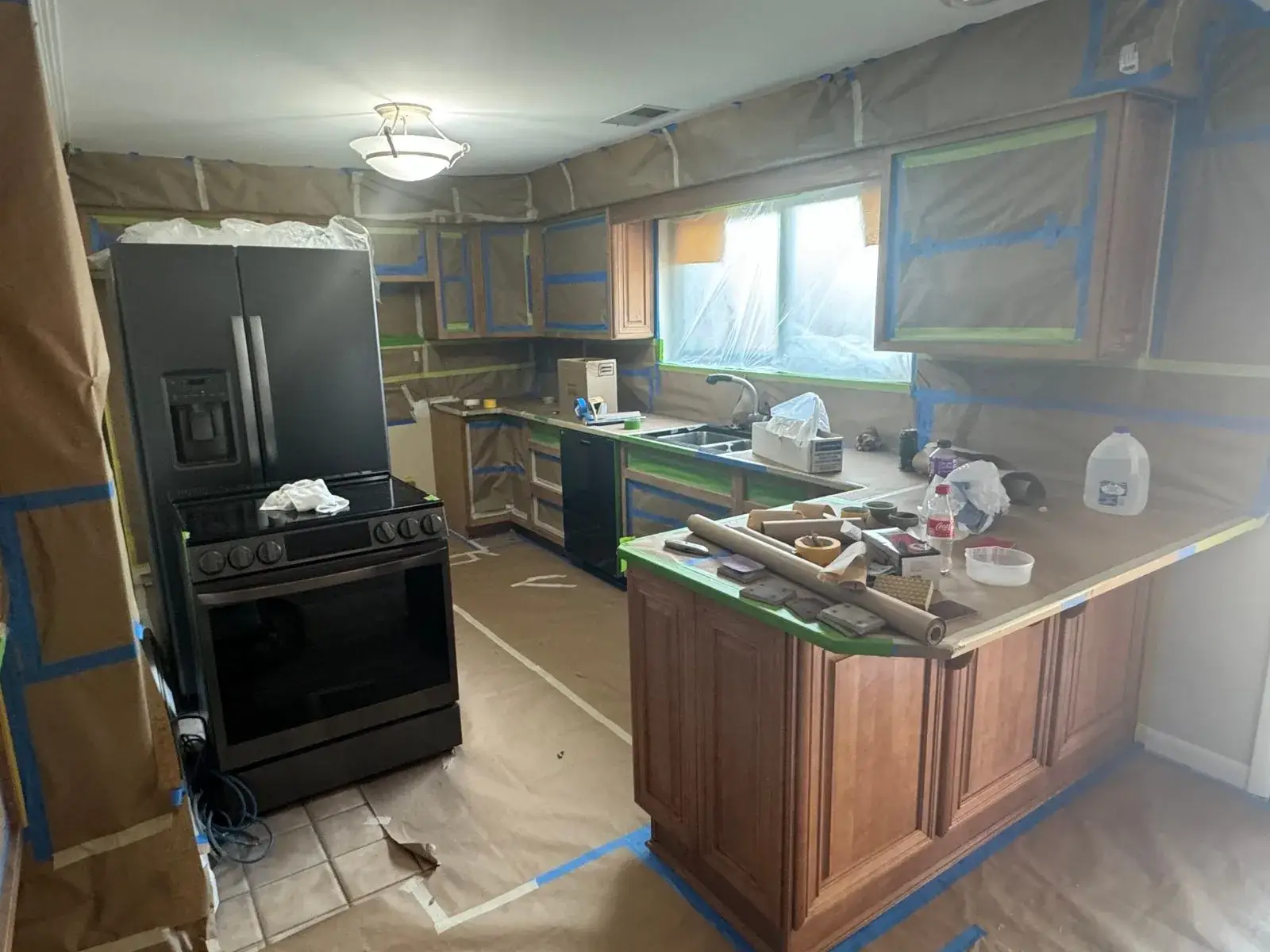 Before: kitchen wood cabinets to white uppers with a dark peninsula