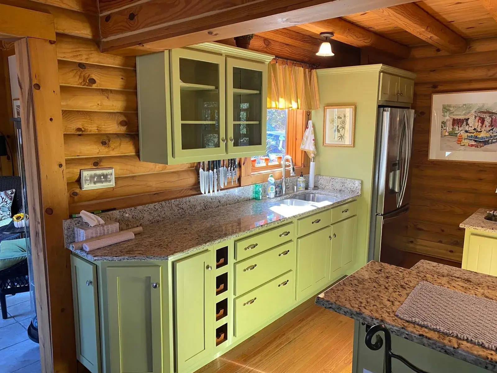 After: log cabin kitchen painted green