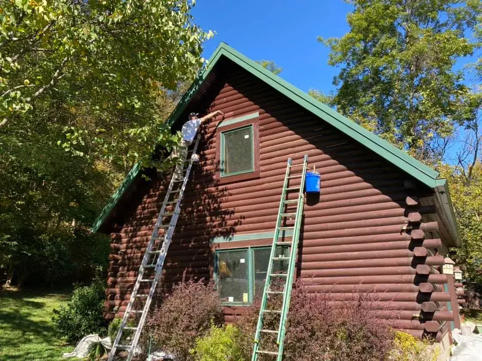 Before: log home exterior restained, green metal roof