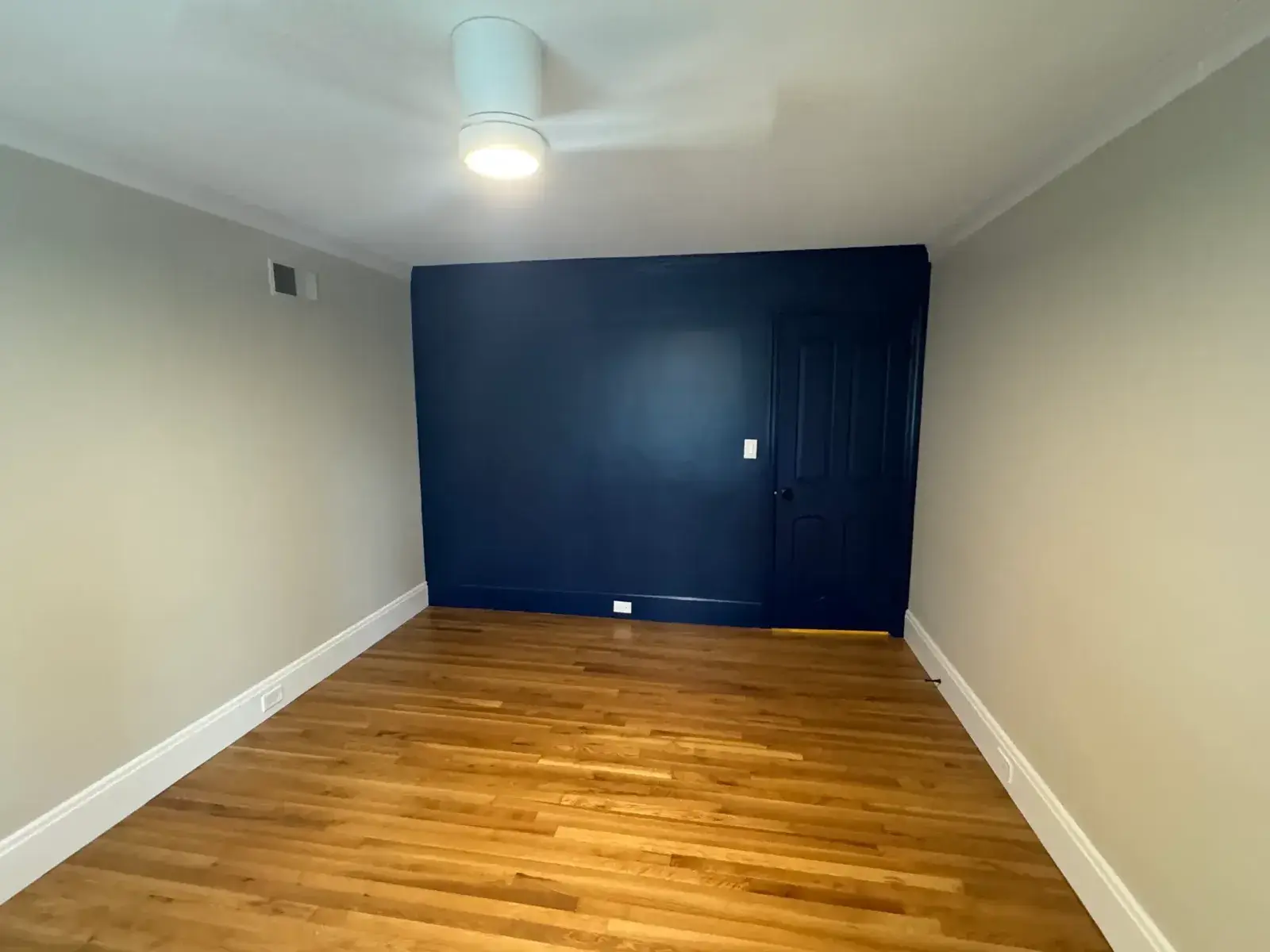 After: navy accent wall, two-tone bedroom and living room