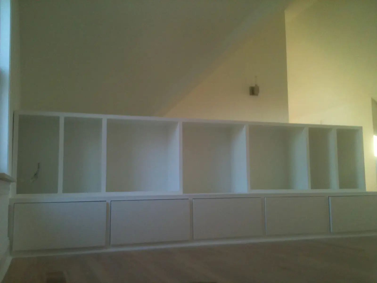 A white built-in storage unit with open shelving above a row of cabinets. - My Personal Painter - My Personal Painter After: new-build craftsman house: exterior and interior