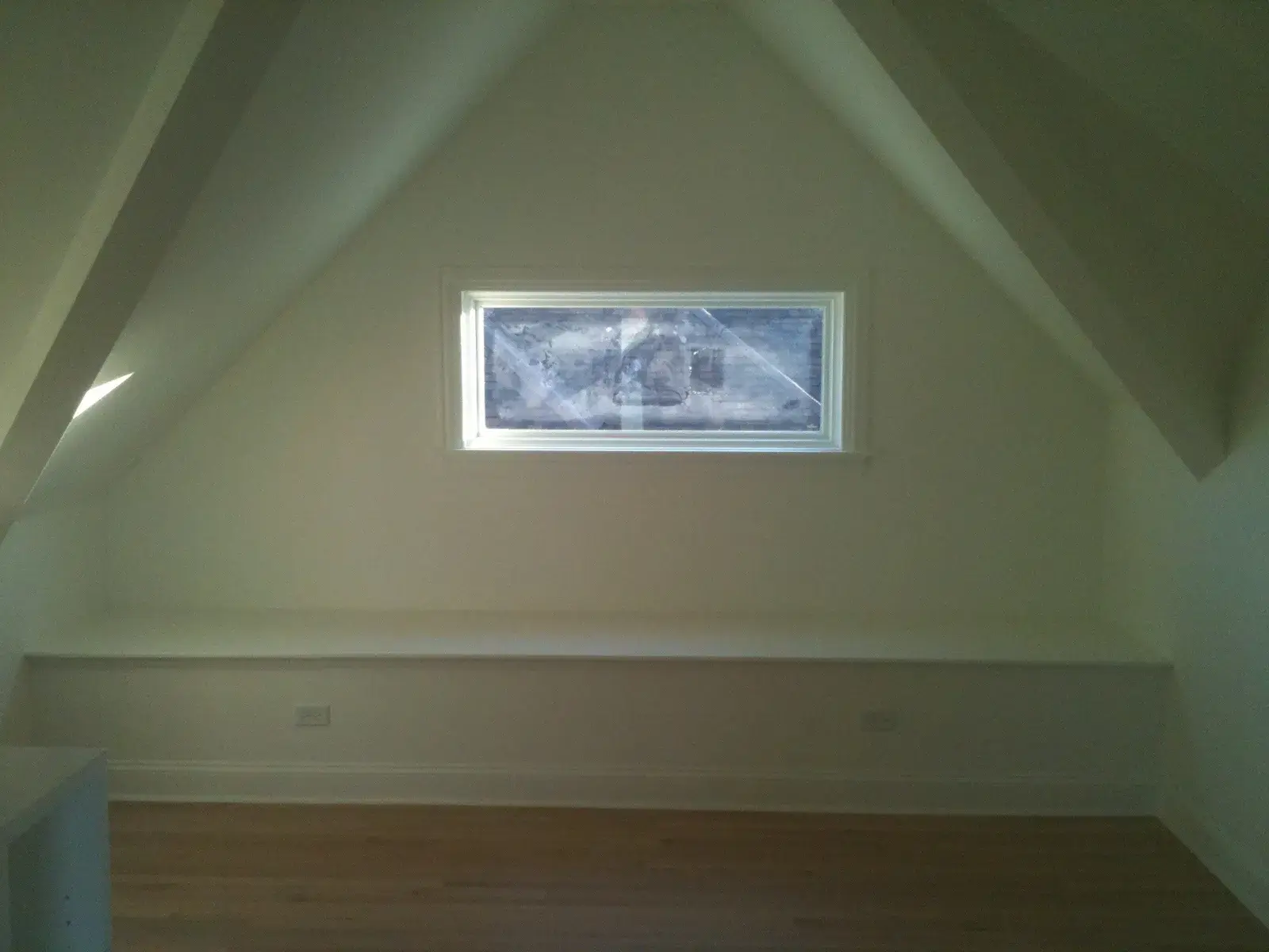 An attic room with a wide built-in bench seat beneath a rectangular window. - My Personal Painter - My Personal Painter After: new-build craftsman house: exterior and interior