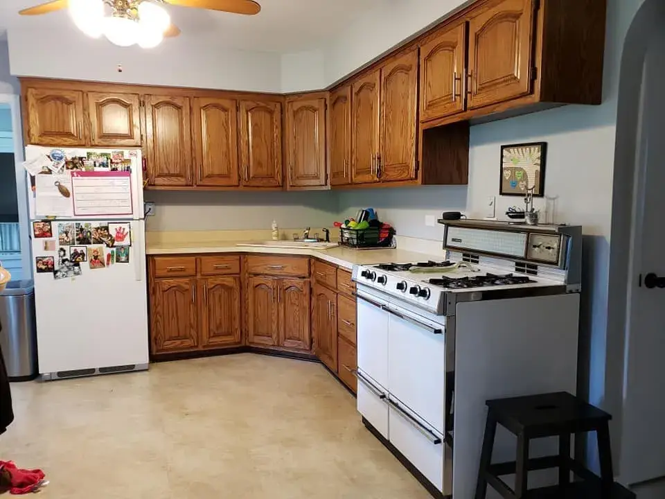 Before: oak kitchen: white uppers, dark gray lowers