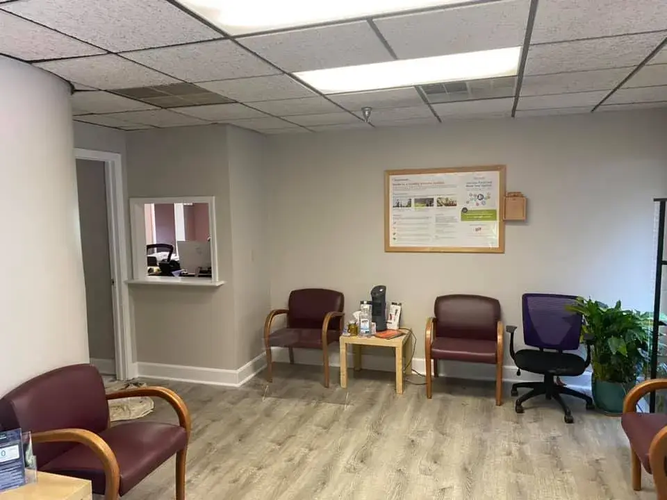 After: office interior repainted: red accent wall, waiting room, hallway, restroom