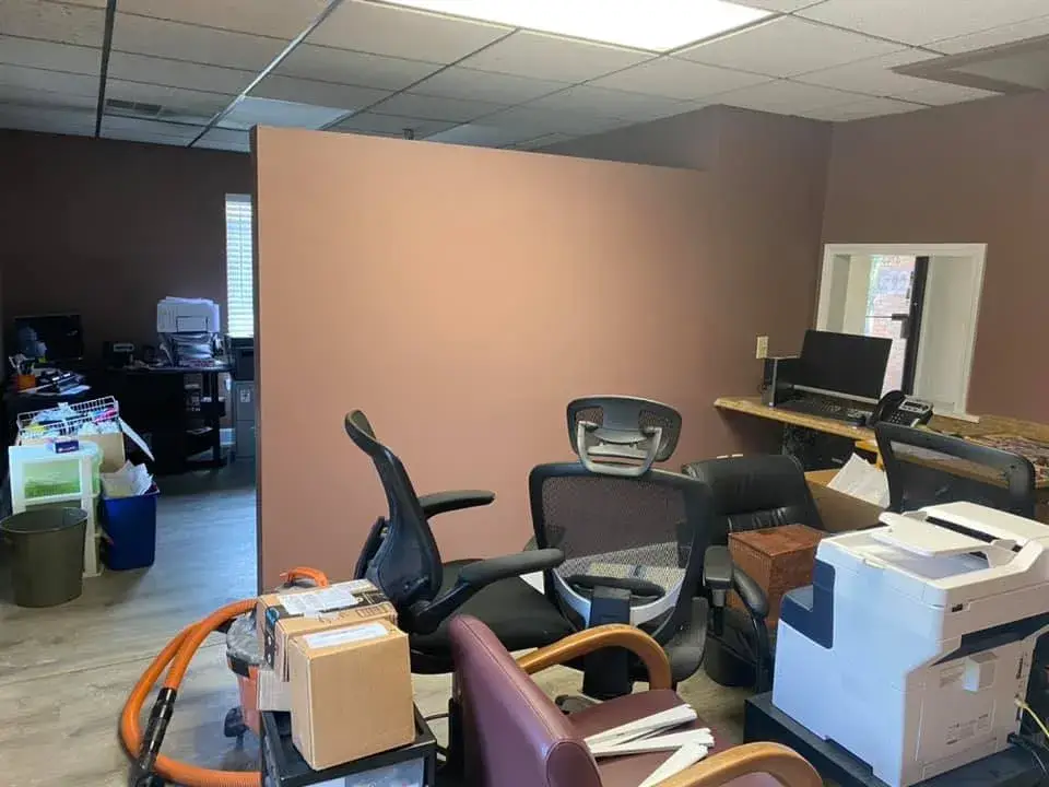 After: office interior repainted: red accent wall, waiting room, hallway, restroom
