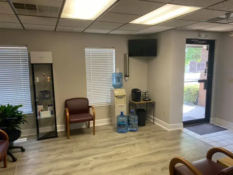 After: office interior repainted: red accent wall, waiting room, hallway, restroom