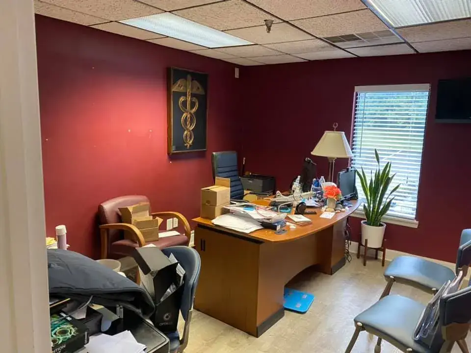After: office interior repainted: red accent wall, waiting room, hallway, restroom