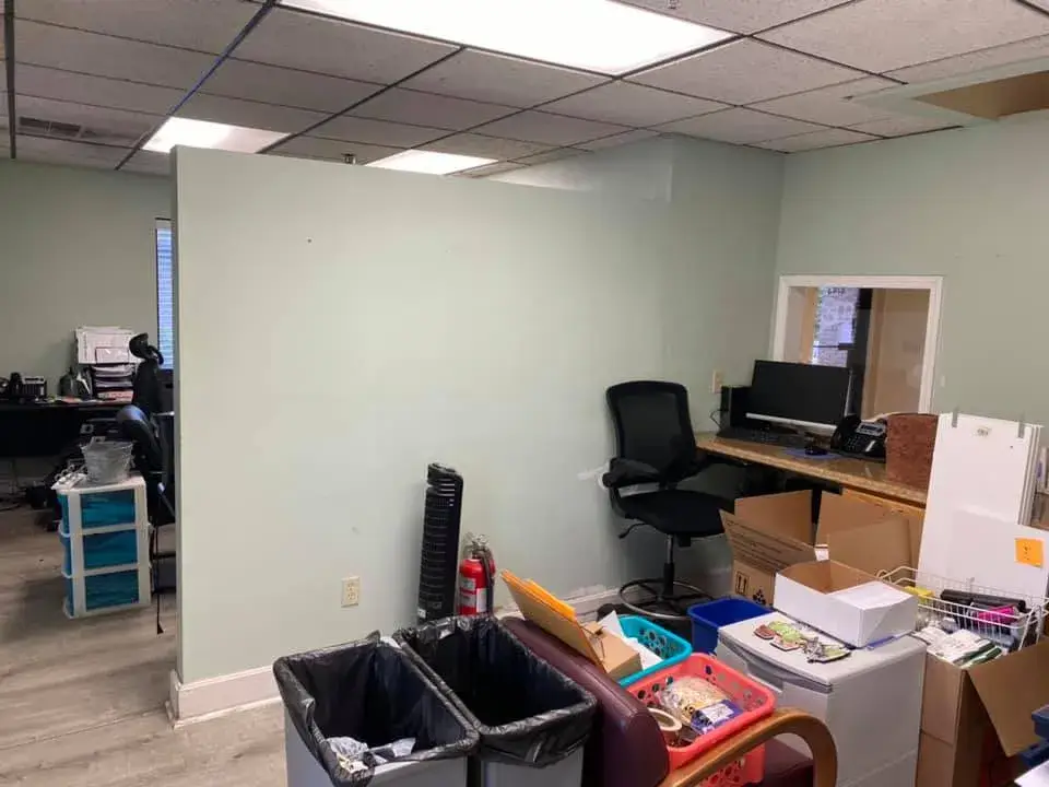 After: office interior repainted: red accent wall, waiting room, hallway, restroom