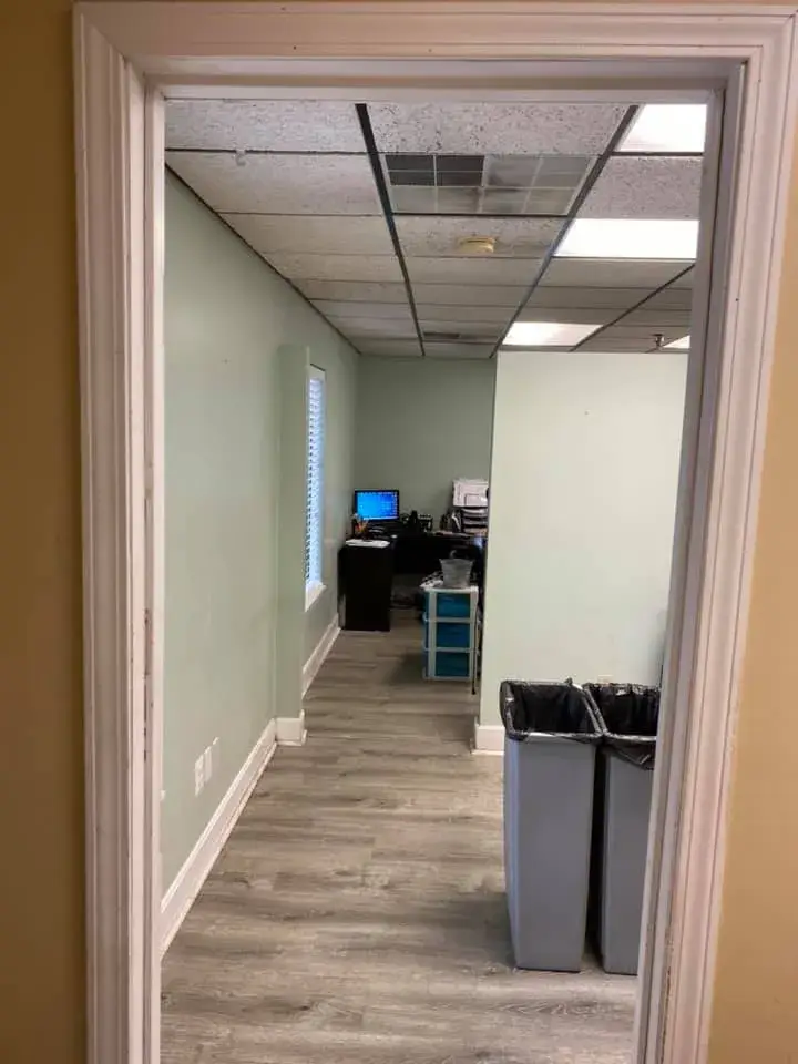 After: office interior repainted: red accent wall, waiting room, hallway, restroom