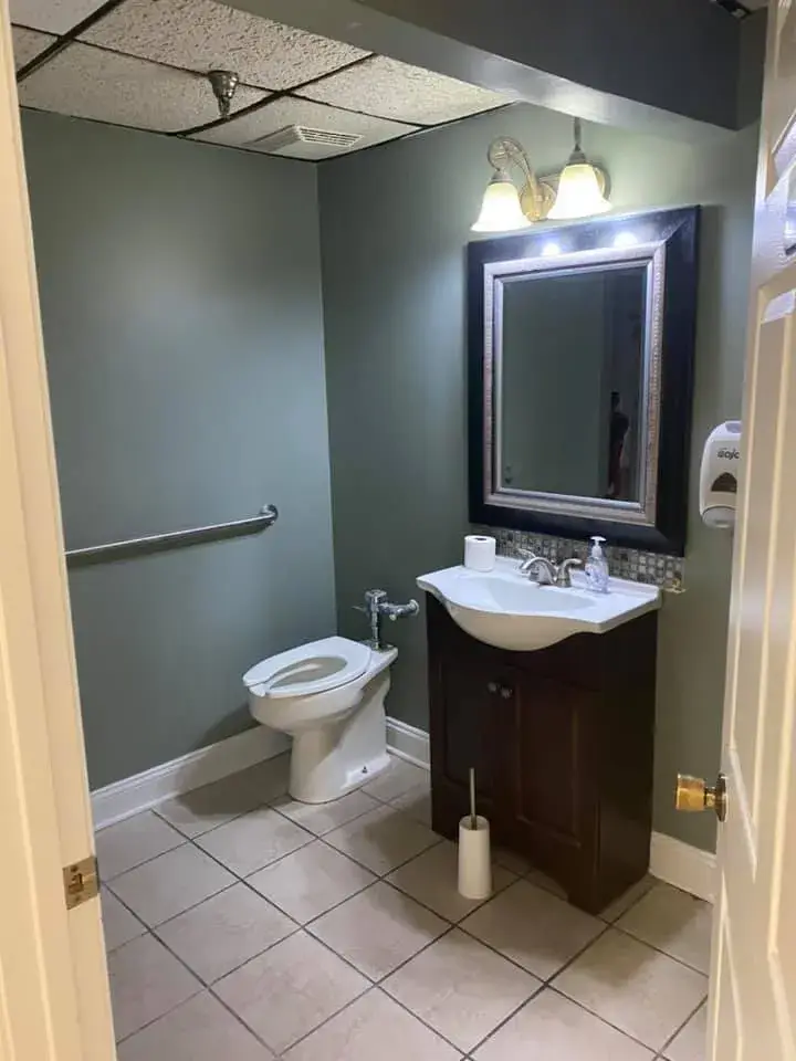 After: office interior repainted: red accent wall, waiting room, hallway, restroom