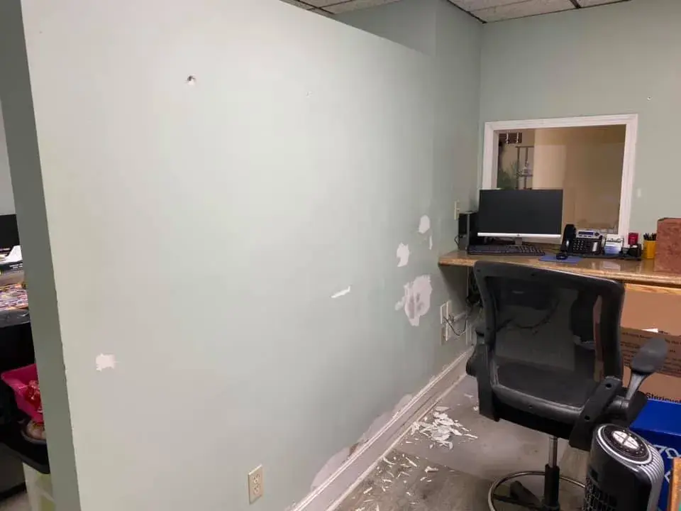 Before: office interior repainted: red accent wall, waiting room, hallway, restroom