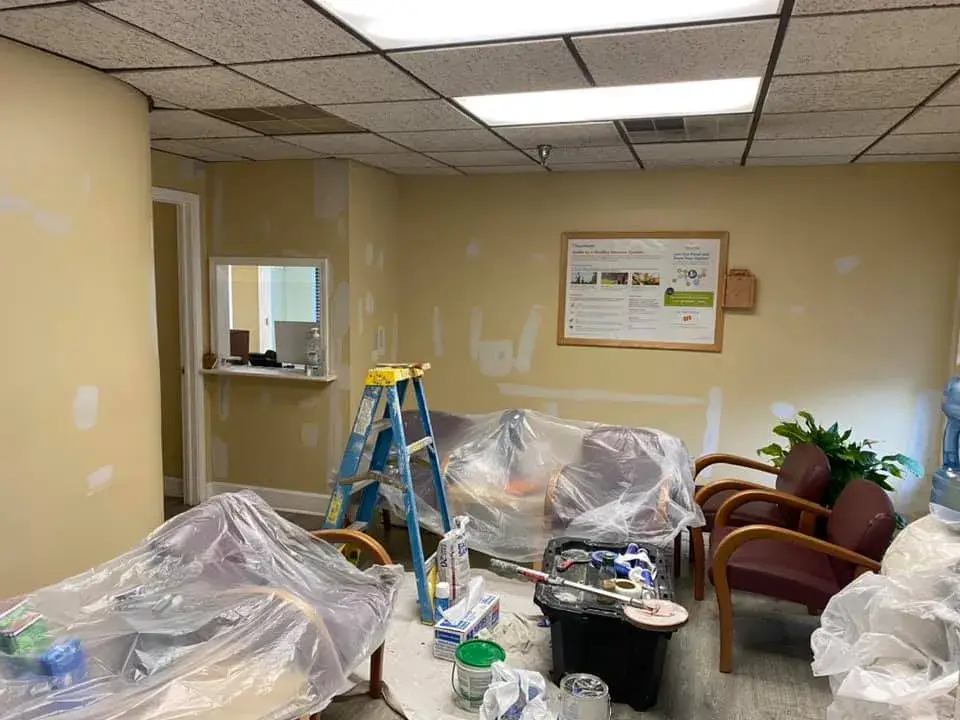 In progress: office interior repainted: red accent wall, waiting room, hallway, restroom