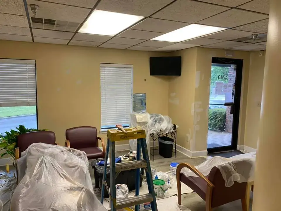 In progress: office interior repainted: red accent wall, waiting room, hallway, restroom