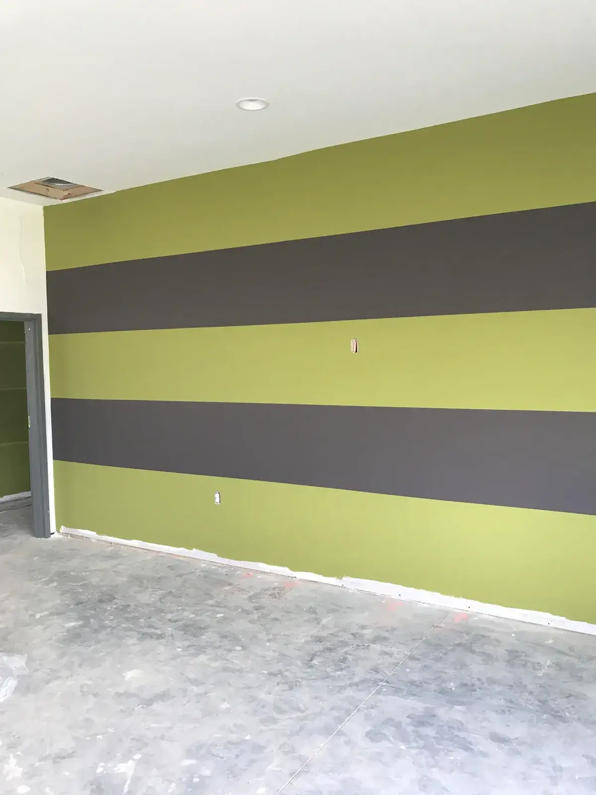 After: olive and charcoal striped commercial walls