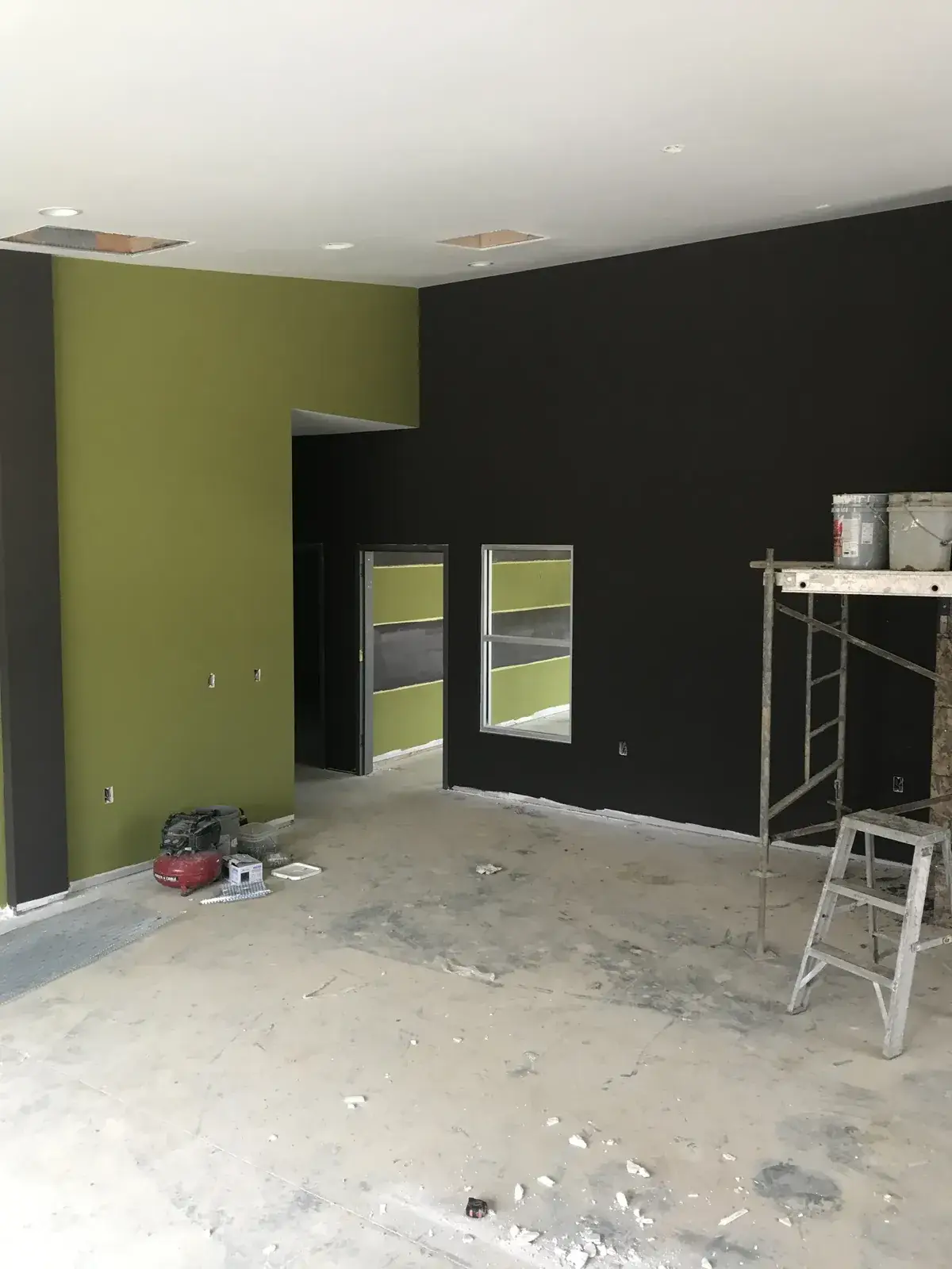 Before: olive and charcoal striped commercial walls