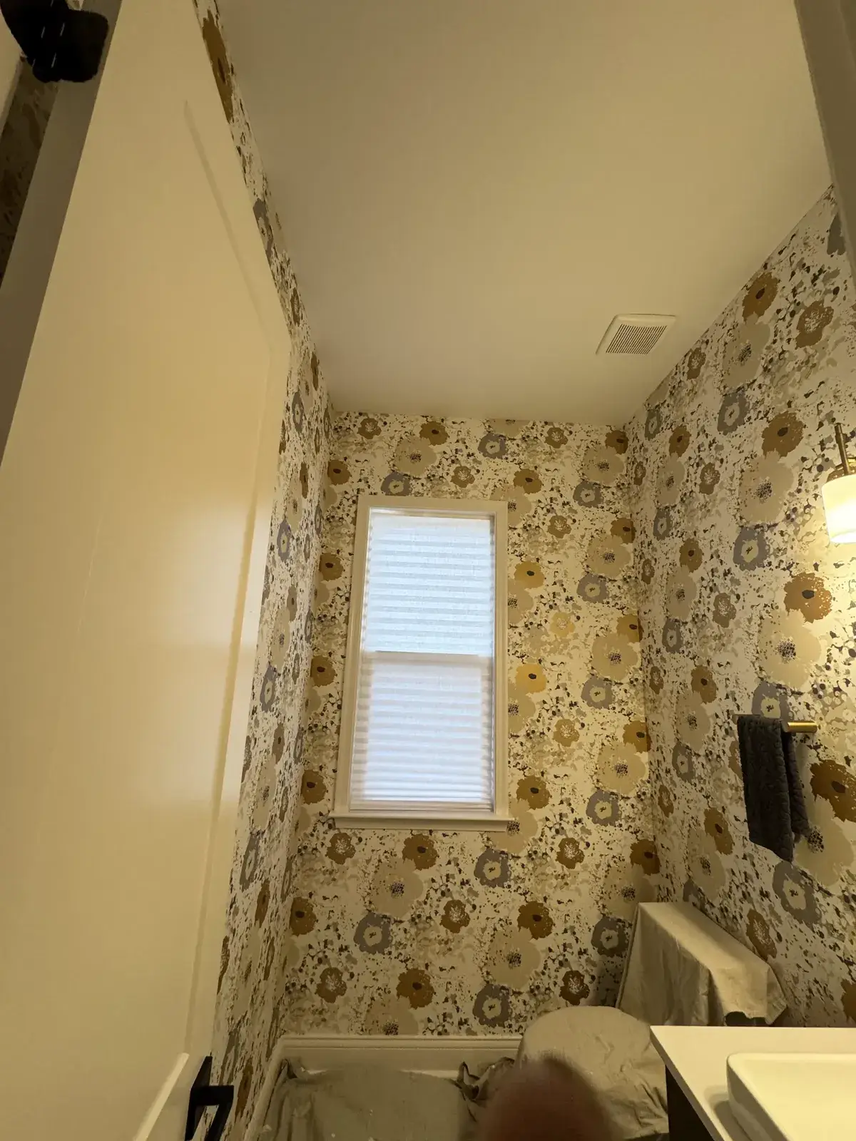 Small bathroom with floral wallpaper, a single window with blinds, and a white sink. - My Personal Painter - My Personal Painter Before: powder room ceiling painted dark brown, bathroom wainscoting and green walls