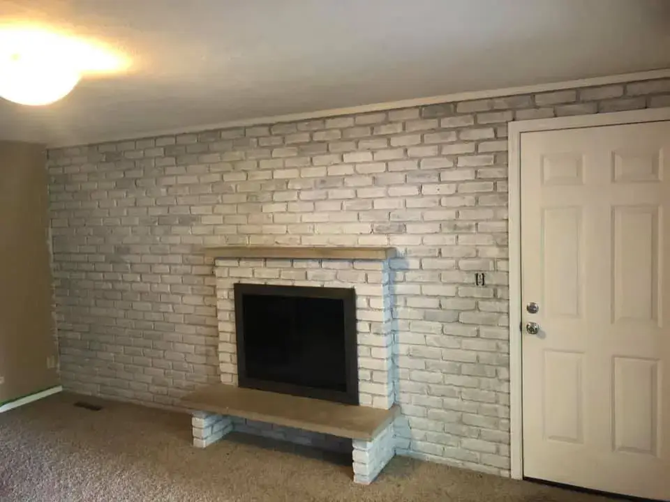 After: red brick fireplace wall whitewashed