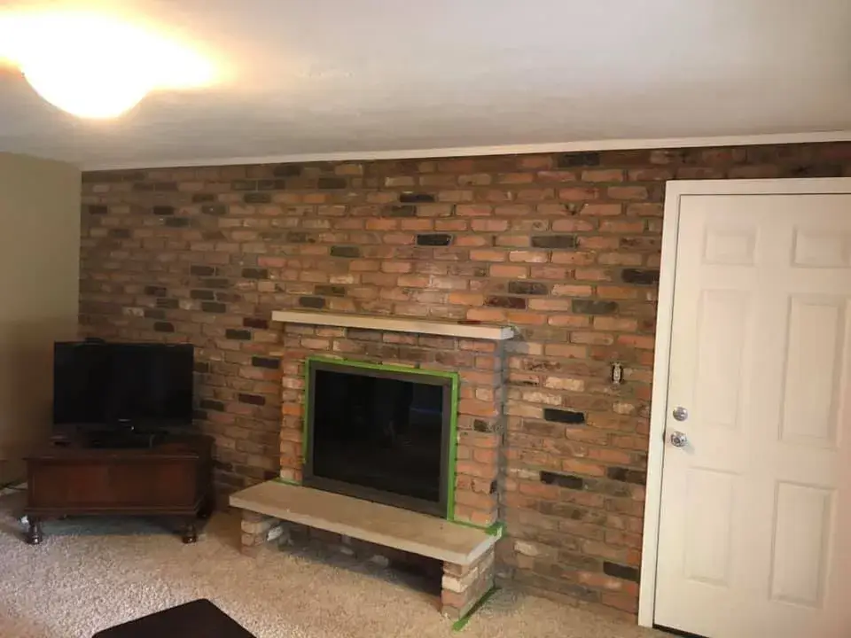 Before: red brick fireplace wall whitewashed