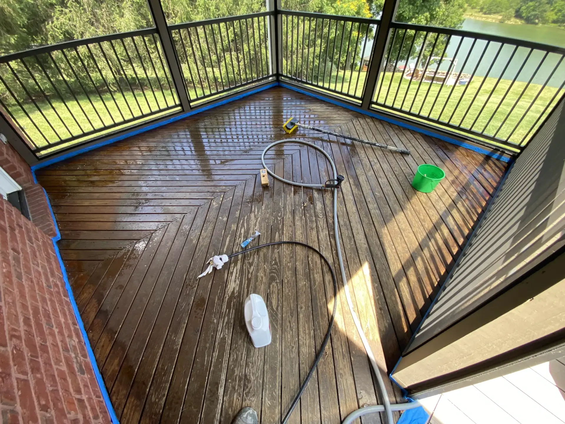 Weathered herringbone screened porch deck before staining