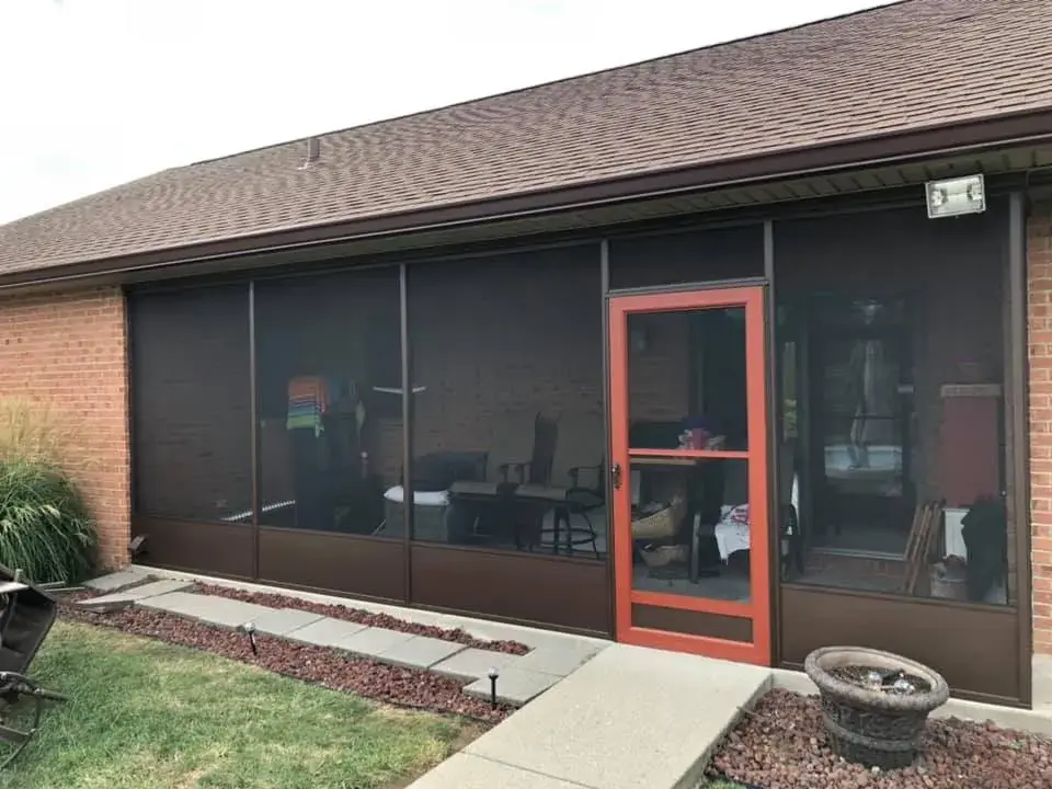 After: screened porch frame painted dark brown on brick ranch
