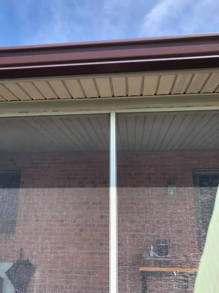 Before: screened porch frame painted dark brown on brick ranch