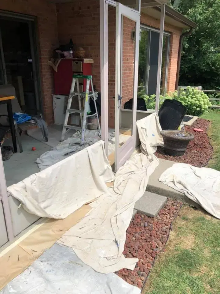 In progress: screened porch frame painted dark brown on brick ranch