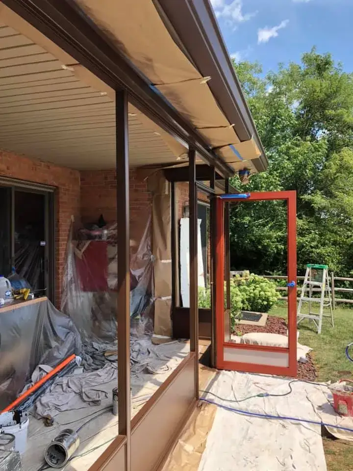 In progress: screened porch frame painted dark brown on brick ranch