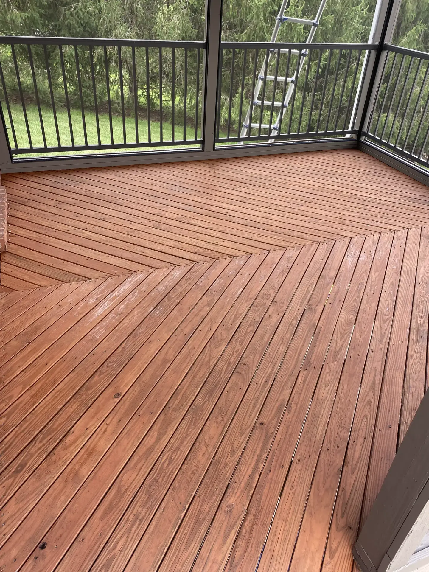 Herringbone screened porch deck after cleaning and staining