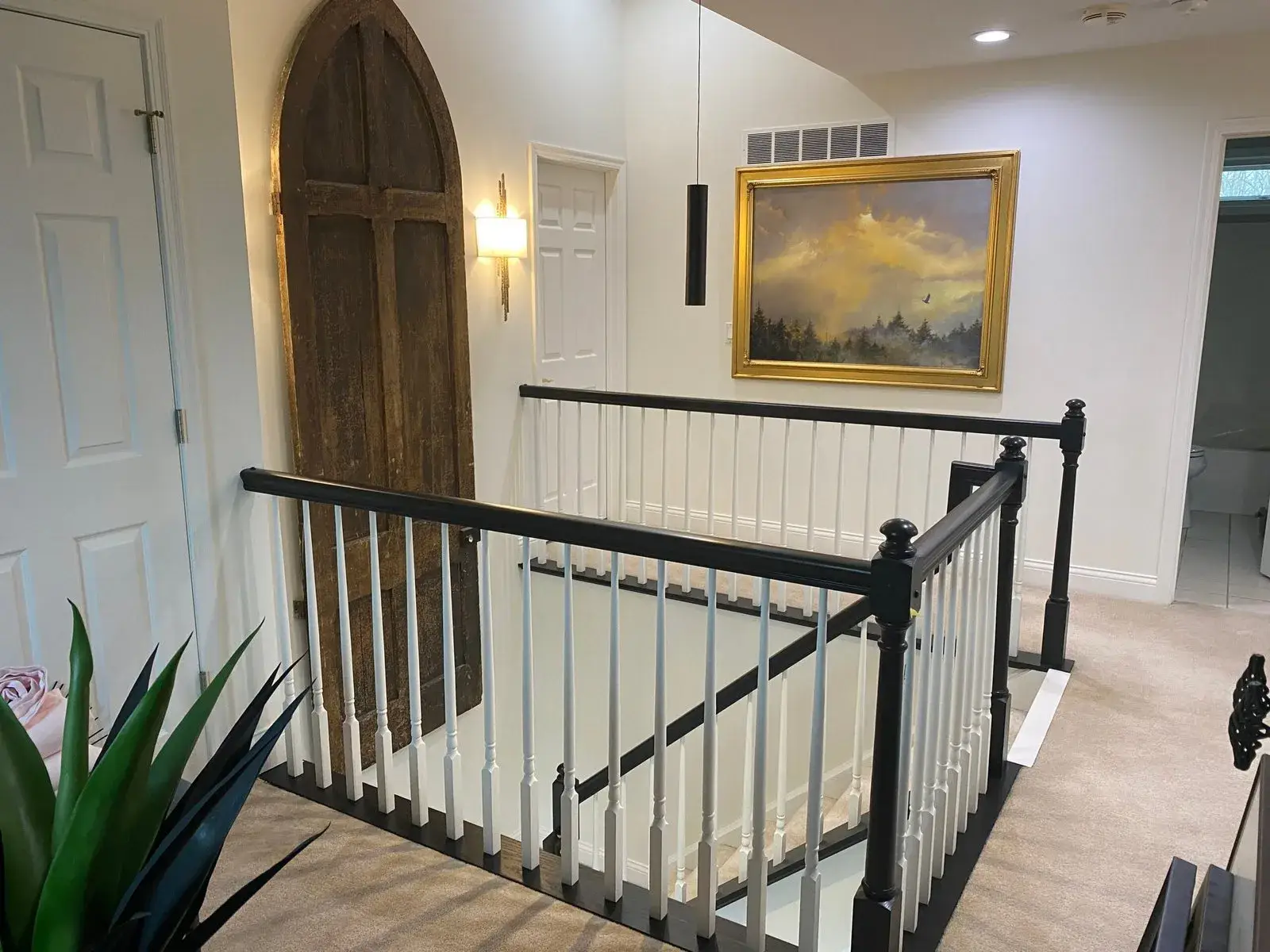 After: staircase railing painted black
