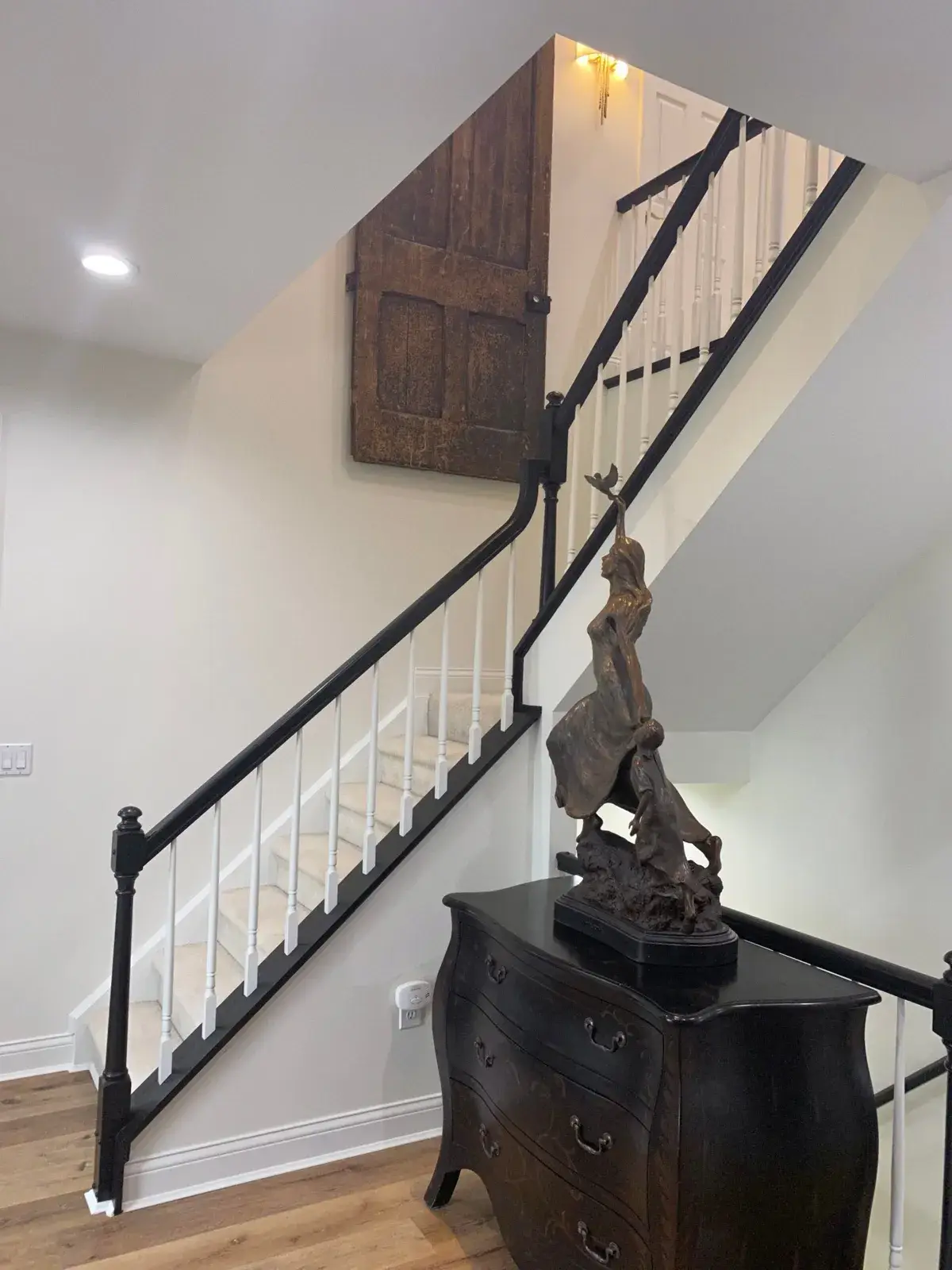 After: staircase railing painted black