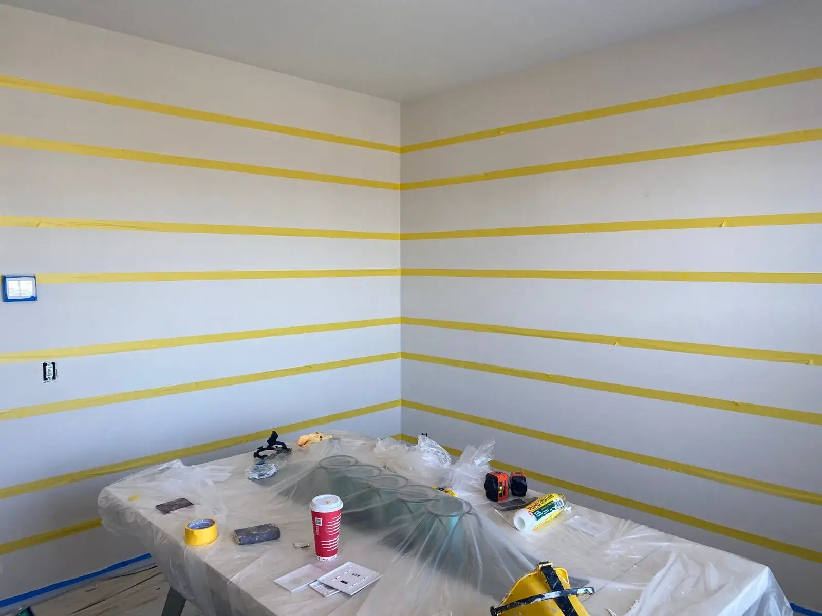 In progress: staircase with black spindles, dining room and bedroom stripes, bathroom vanity